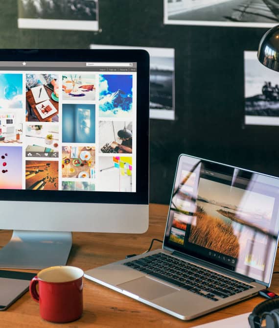 Foto van online marketing content creatie met een iMac op een bureau, toont iemand die werkt aan marketingprojecten